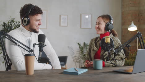 Male-and-Female-Podcast-Hosts-Speaking-in-Mics-in-Recording-Studio